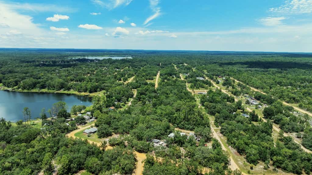 Lakeside community with sandy roads seen from the air in inland Florida